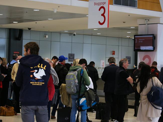 SYDNEY, AUSTRALIA - September 04, 2022: A general view of travellers seen waiting for their bags at the baggage terminal at Qantas Domestic Airport   as Qantas ground workers prepare to strike again with Qantas passengers facing major disruptions after ground handlers vote to strike over the airline's âdistressingâ wages crisis in Sydney. Picture Newscorp - Daily Telegraph/ Gaye Gerard.