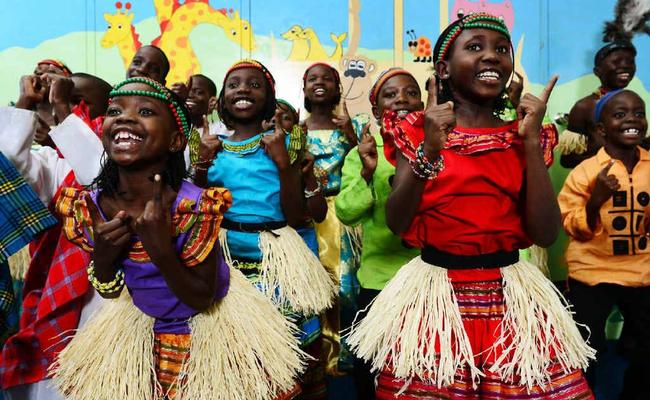 Alimo Prossy (front left) and Namusoke Regina (front right) perform with the Watoto Children's Choir at the Central Church Ipswich. Picture: David Nielsen