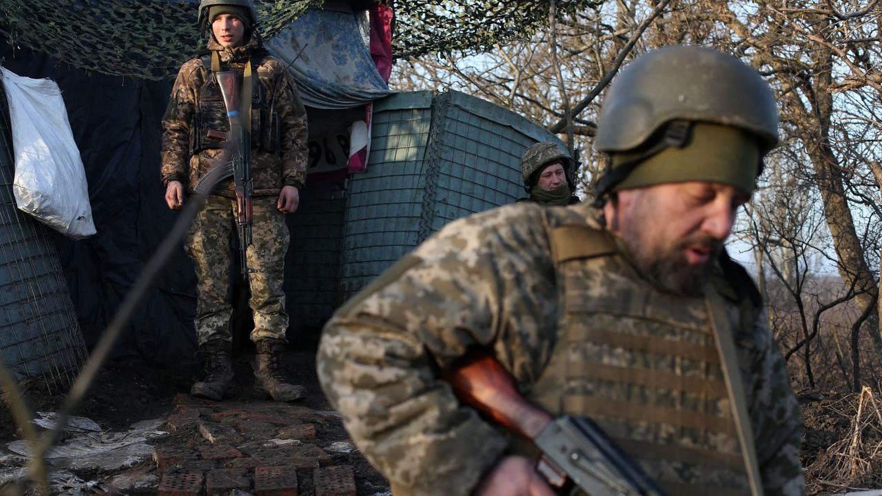 Servicemen of the Ukrainian Military Forces walk on the front line with Russian-backed separatists near Novohnativka, Donetsk region. Picture: Anatolii STEPANOV/AFP