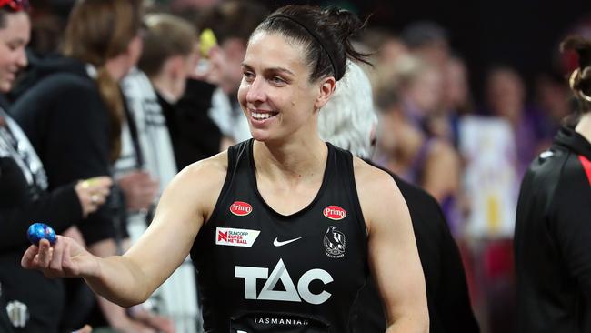 Ash Brazill of the Magpies gives out Easter eggs to fans after coming off for a concussion check during her team’s round four Super Netball match against the Queensland Firebirds at John Cain Arena. Photo: Getty Images