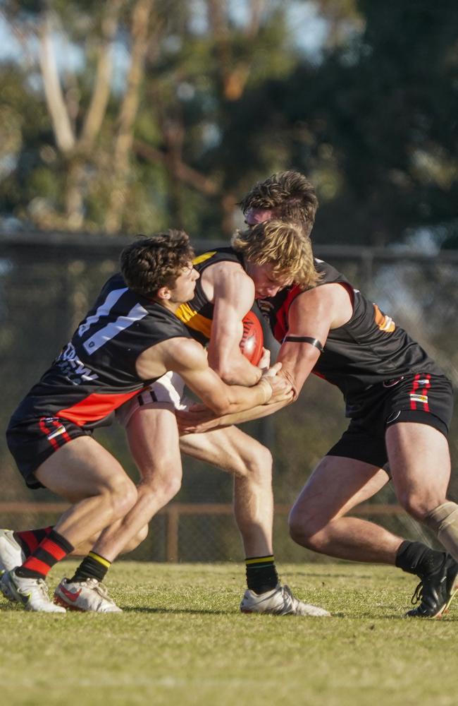 Nick Collier (middle) is tackled. Picture: Valeriu Campan