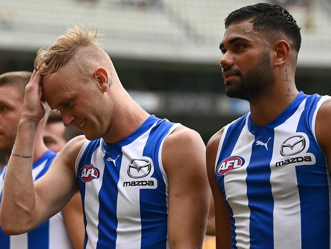 MELBOURNE, AUSTRALIA - MARCH 20: Jaidyn Stephenson and Tarryn Thomas of the Kangaroos walk off the field after losing the round one AFL match between the Hawthorn Hawks and the North Melbourne Kangaroos at Melbourne Cricket Ground on March 20, 2022 in Melbourne, Australia. (Photo by Quinn Rooney/Getty Images)