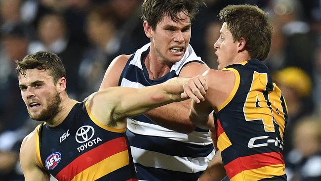 The Crouch boys go head-to-head with Tom Hawkins. Picture: AAP Images