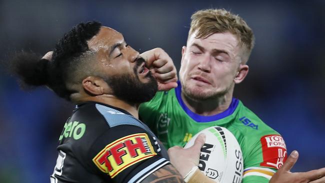 GOLD COAST, AUSTRALIA - JULY 17:  Hudson Young of the Raiders puts a fend on Siosifa Talakai of the Sharks during the round 18 NRL match between the Canberra Raiders and the Cronulla Sharks at Cbus Super Stadium, on July 17, 2021, in Gold Coast, Australia. (Photo by Regi Varghese/Getty Images)