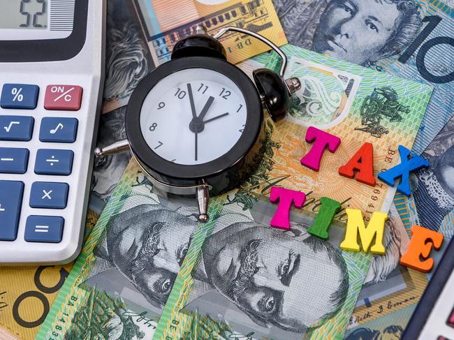 Australian dollars with clock and 'tax time' text; taxation generic calculator money