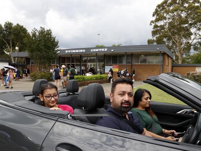 Tony and Rita Talwar picking their daughter Naisha up from her swimming carnival at Merrylands Swimming Centre. Picture: Jonathan Ng