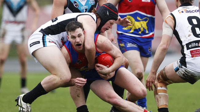 Huonville's Alex Vincent is tackled by Cygnet's Murray Bastick. Picture: Zak Simmonds