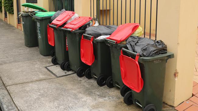 Full garbage bins, overloaded with rubbish on Hill and Balmain road in Leichhardt. The changes to collection have meant bins are always full. Picture Rohan Kelly.