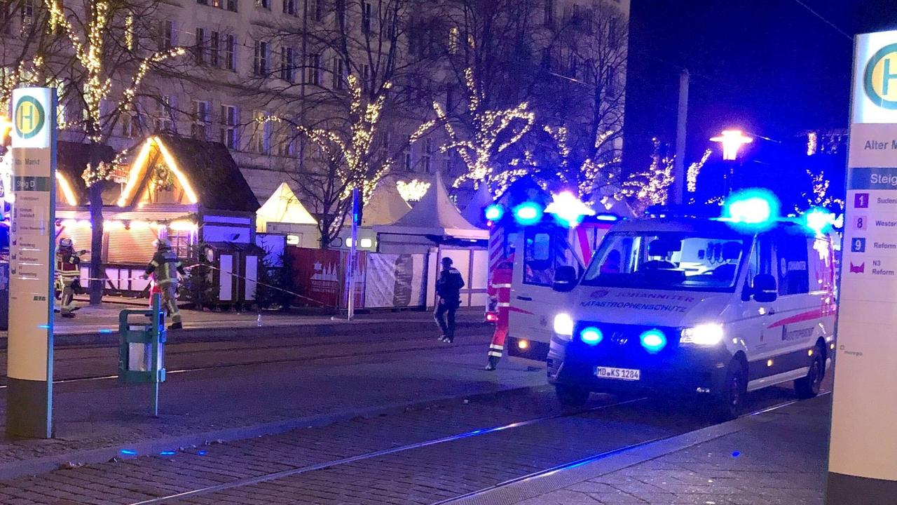 An ambulance stands next to the Christmas market.