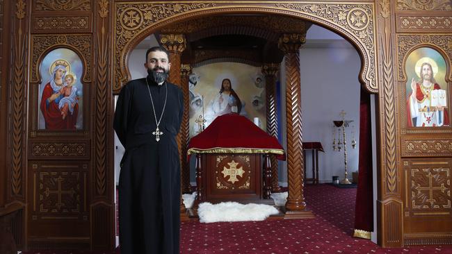 Fr Tadros in front of the altar where the candles, veil and woodwork pieces from Egypt. Picture: David Swift