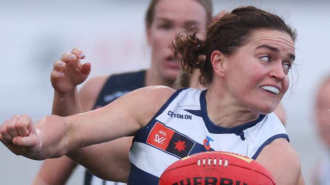 MELBOURNE, AUSTRALIA - SEPTEMBER 14: Meghan McDonald of the Cats handballs during the round three AFLW match between Carlton Blues and Geelong Cats at Ikon Park, on September 14, 2024, in Melbourne, Australia. (Photo by Daniel Pockett/Getty Images)