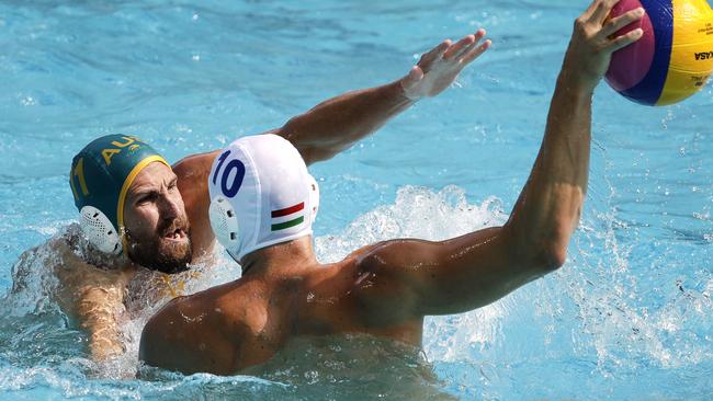 Hungary's Denes Varga, right, takes a shot as Australia's Rhys Howden, left, defends during their men's water polo preliminary round match at the 2016 Summer Olympics in Rio de Janeiro, Brazil, Monday, Aug. 8, 2016. (AP Photo/Eduardo Verdugo)