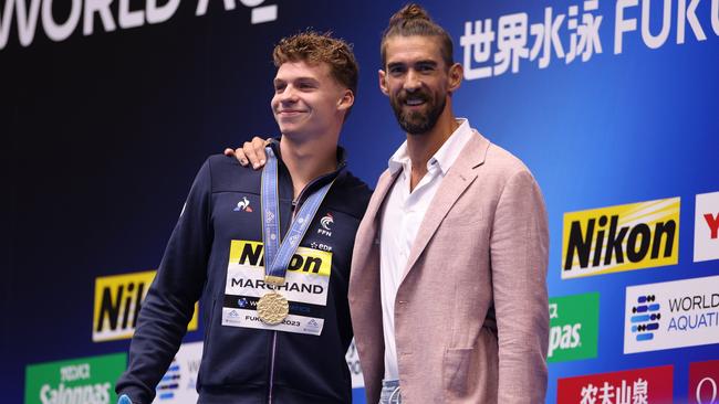 Michael Phelps congratulates Leon Marchand after be broke his last world record. (Photo by Adam Pretty/Getty Images)