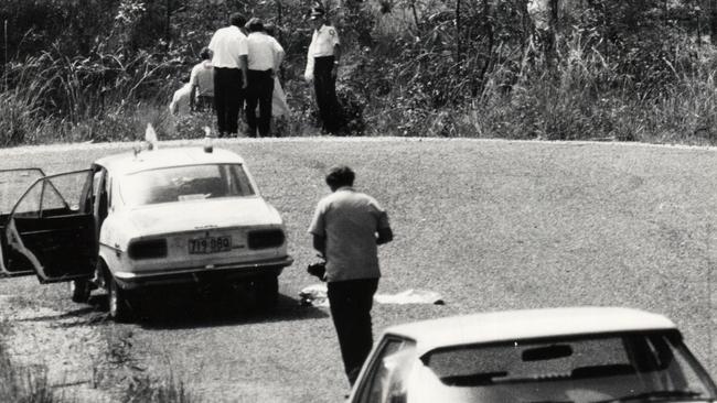 Police and government medical officers at the scene in Gaven where the body of Linda Reed was discovered.