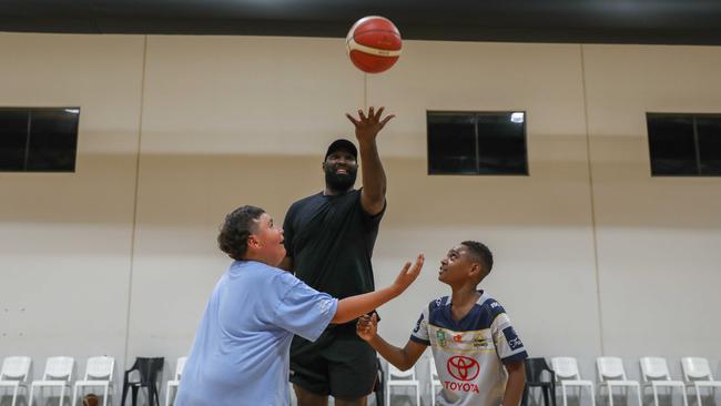 Memphis Walker and Pranton Mabo going for the jump ball with Cairns Taipans player Nate Jawai at the first midnight basketball night. Picture: Jasmine Amis