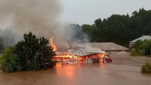 A house in Lismore burst into flames as the residents were rescued via boat in the nick of time. Picture: https://www.facebook.com/Pennyevansart/posts/360213912778637