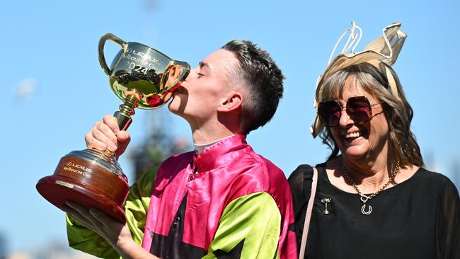 MELBOURNE, AUSTRALIA - NOVEMBER 05: Robbie Dolan kisses the trophy with trainer Sheila Laxon after Knight's Choice won Race 7, the Lexus Melbourne Cup - Betting Odds during Melbourne Cup Day at Flemington Racecourse on November 05, 2024 in Melbourne, Australia. (Photo by Vince Caligiuri/Getty Images)