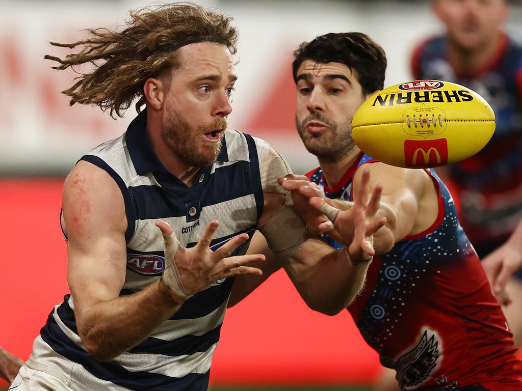 Cam Guthrie had a blinder for the Cats. Here, he gets one ahead of the busy Christian Petracca. Picture: Michael Klein