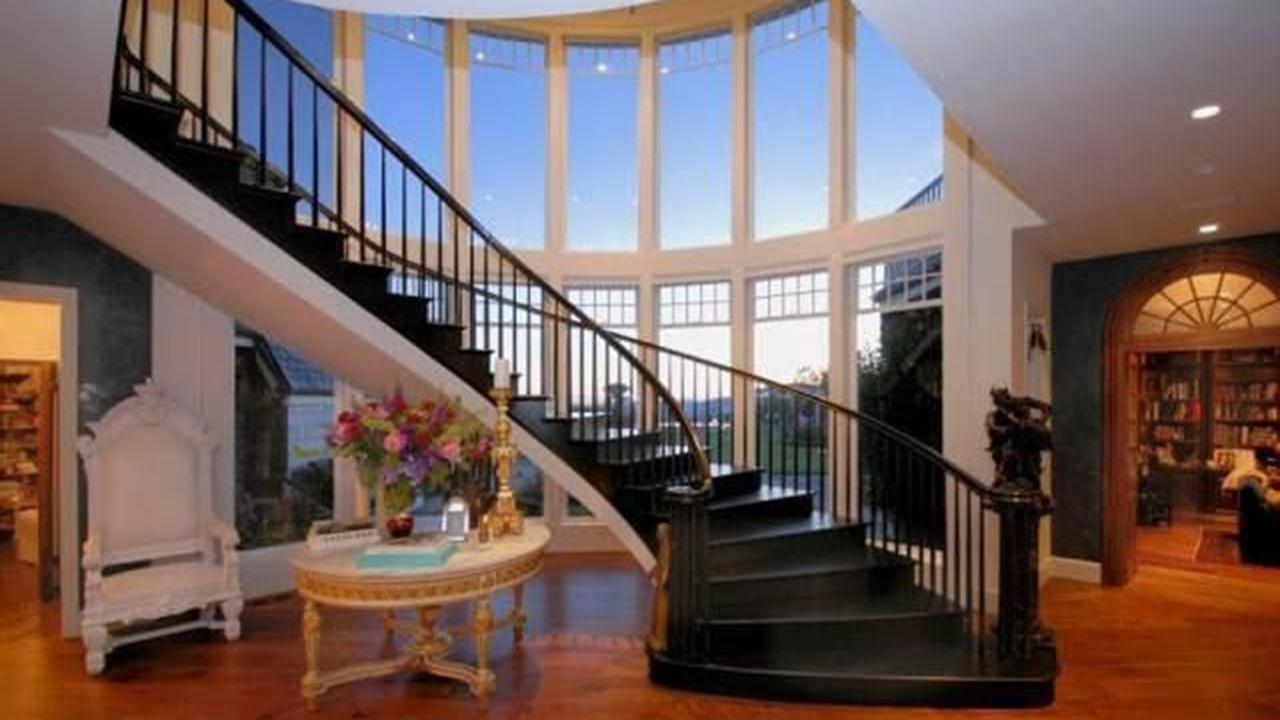 The main foyer has floor-to-ceiling windows and a grand staircase. Picture: Wire/Realtor.com