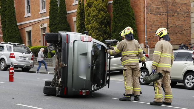 Emergency services were called to a car crash on Davey Street where a car was flipped on its side. Picture: Zak Simmonds