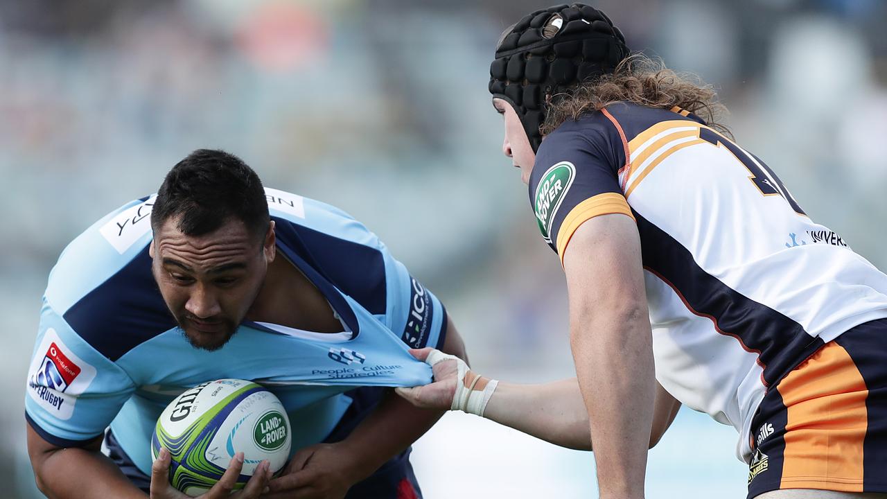 Andrew Tuala of the Waratahs Is tackled by Lachlan Lonergan of the Brumbies.