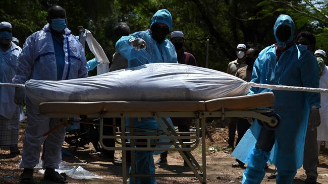 Volunteers prepare to bury a body of a Covid-19 coronavirus victim in Chennai, India. The Delta variant emerged in India around October last year and has now spread to 100 countries. Picture: AFP