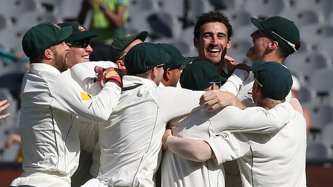 Players swamp Starc after he cleaned up the tail. Picture: Wayne Ludbey