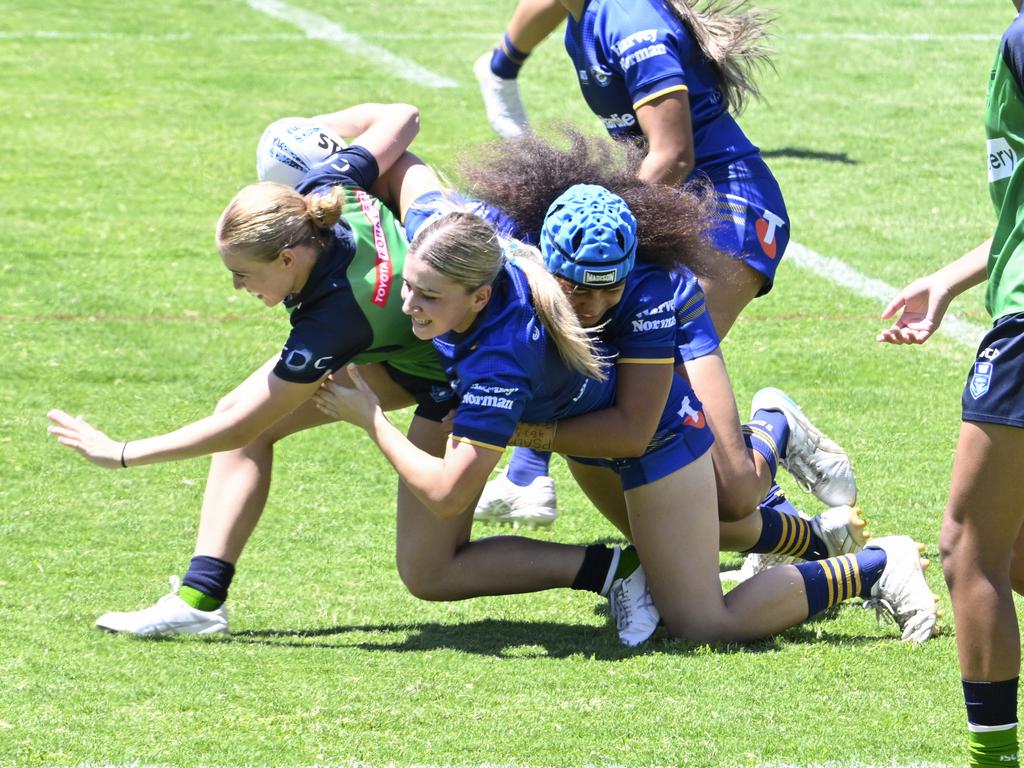 Holly Williams is tackled by Aaliyah Soufan (left) and Fontayne Tufuga, Picture: Martin Ollman