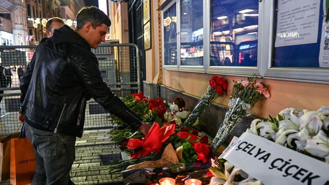 A man lays a flower outside the Russian consulate in Istanbul a day after the deadly attack. Picture: Ozan KOSE / AFP