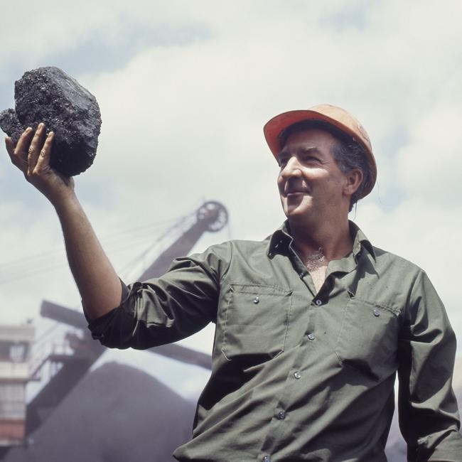 A miner displays the “black gold” produced at the Peak Downs coal mine near Moranbah.