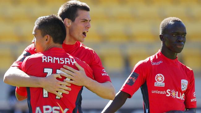 Tomi Juric of Adelaide United is congratulated on his goal by ex teammate Iain Ramsay with Awer Mabil looking on in Wellington in 2013. Picture: Hagen Hopkins/Getty Images