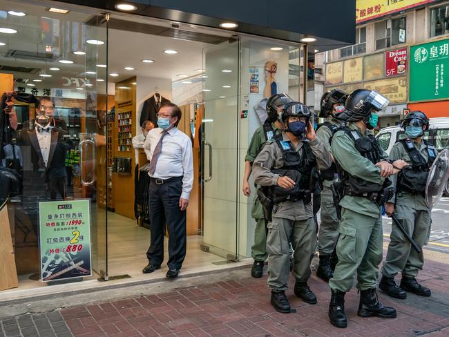 Riot police stand guard outside a shop during a protest against the national security law. Picture: Anthony Kwan/Getty Images