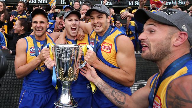 Dom Sheed, Jeremy McGovern, Tom Barass and Chris Masten hold the premiership cup. Picture: Phil Hillyard