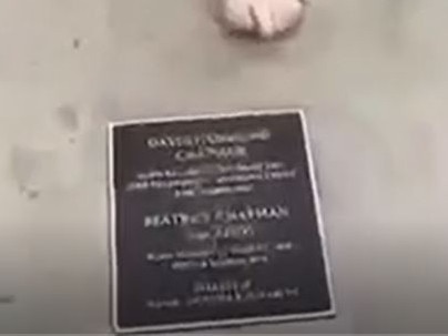 The plaque on David and Beatrice Chapman's grave in the video.