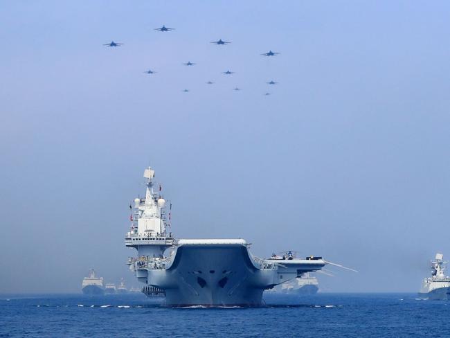 Chinese warships and fighter jets take part in a military display in the South China Sea.