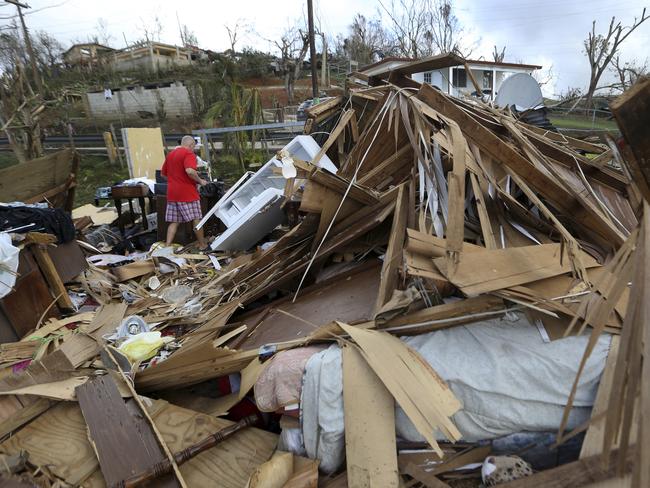 Jose Garcia Vicente walks through rubble of his destroyed home in the aftermath of Hurricane Maria, in Aibonito, Puerto Rico. Picture: Gerald Herbert