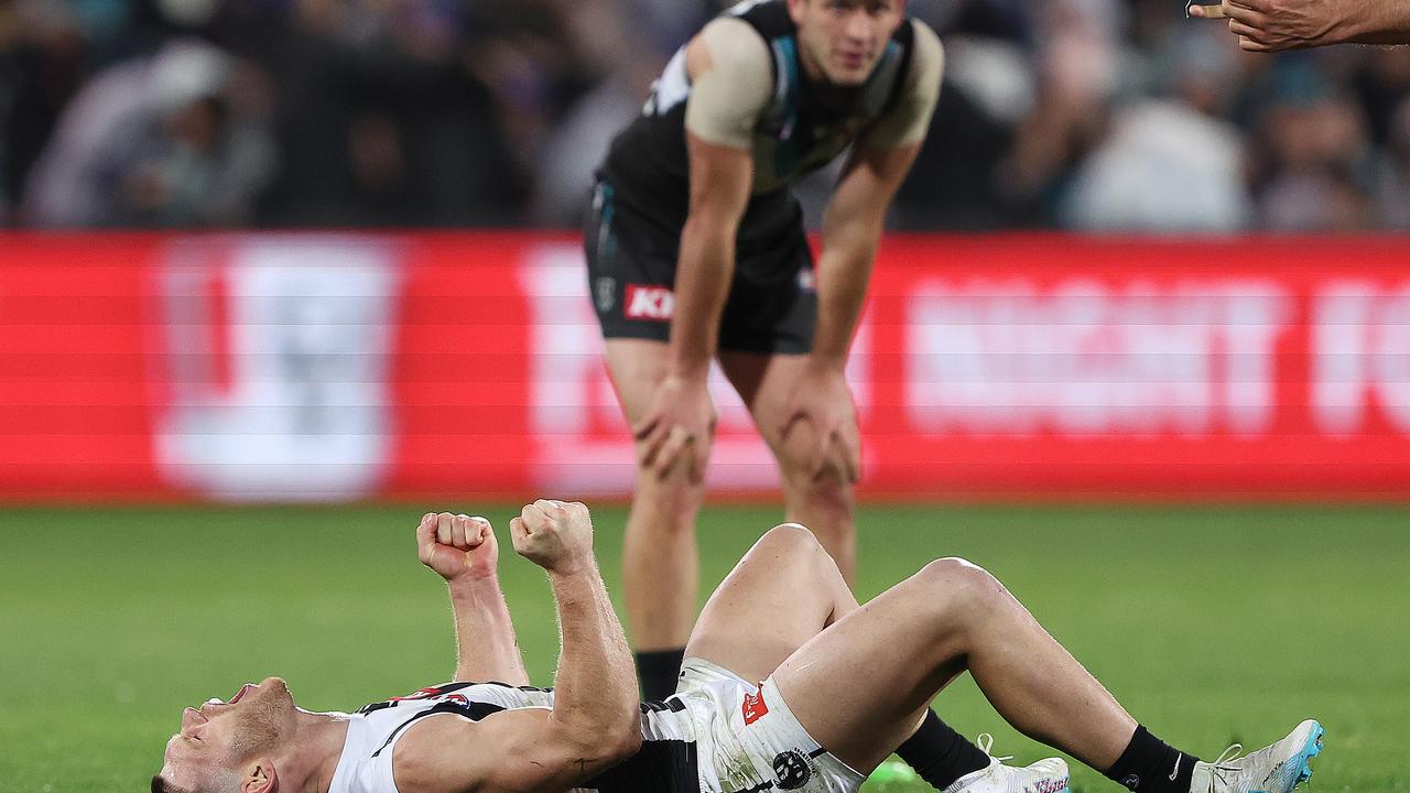 ADELAIDE, AUSTRALIA - JULY 22: Taylor Adams of the Magpies reacts on the siren in his 200th game with Zak Butters of the Power in the background during the 2023 AFL Round 19 match between the Port Adelaide Power and the Collingwood Magpies at Adelaide Oval on July 22, 2023 in Adelaide, Australia. (Photo by Sarah Reed/AFL Photos via Getty Images)