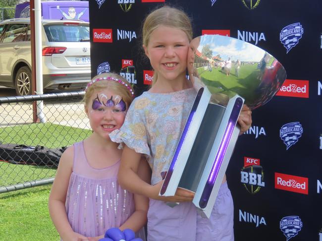 Hurricanes fans Harriet Hendley, six, and Violet Hendley, nine, with the BBL trophy at Tuesday's fan day in Launceston. Picture: Jon Tuxworth