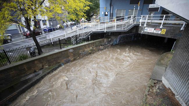 The rivulet on Collins Street, Hobart amid heavy rain. Picture: Chris Kidd.