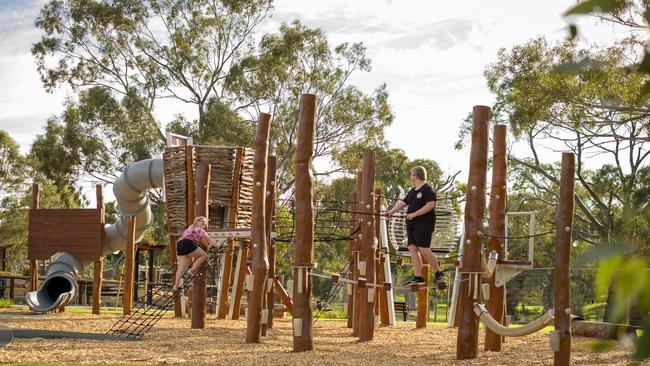 Paige and Zac play on the newly opened Wilfred Taylor Reserve nature playground. Picture: Onkaparinga Council