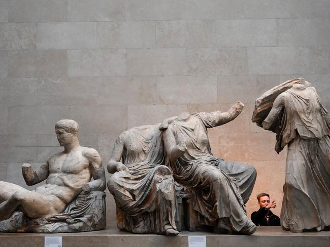 (FILES) Visitors view the Parthenon Marbles, also known as the Elgin Marbles, at the British Museum in London on January 9, 2023. Talks in London on December 3, 2024 between British Prime Minister Keir Starmer and Greek counterpart Kyriakos Mitsotakis have rekindled hopes of a deal for the repatriation of the Parthenon Marbles from the British Museum in 2025. (Photo by Daniel LEAL / AFP) / RESTRICTED TO EDITORIAL USE