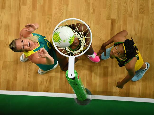 GOLD COAST, AUSTRALIA - APRIL 11:  Caitlin Bassett of Australia (L) scores a goal during the Netball Pool A match between Australia and Jamaica on day seven of the Gold Coast 2018 Commonwealth Games at Gold Coast Convention Centre on April 11, 2018 on the Gold Coast, Australia. (Photo by Dan Mullan/Getty Images)