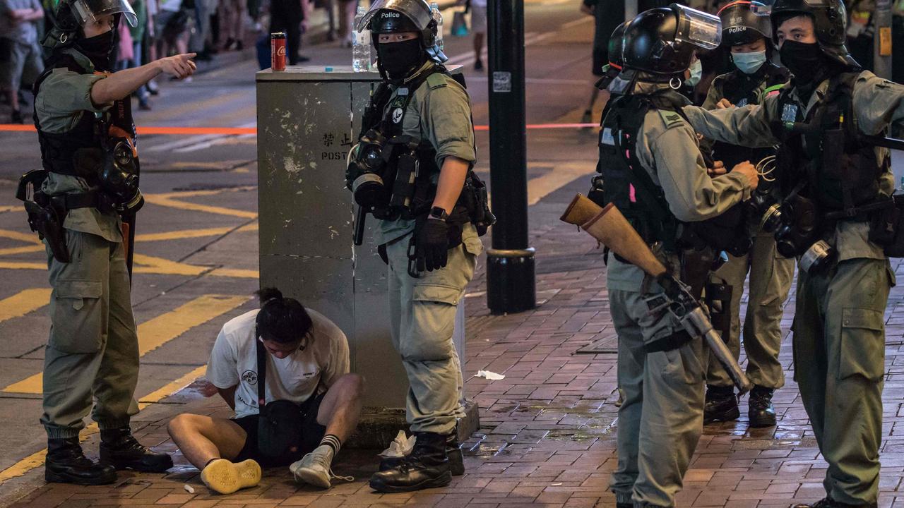 Riot police detain a man after protesters were cleared from a rally area. Picture: Dale De La Rey/AFP