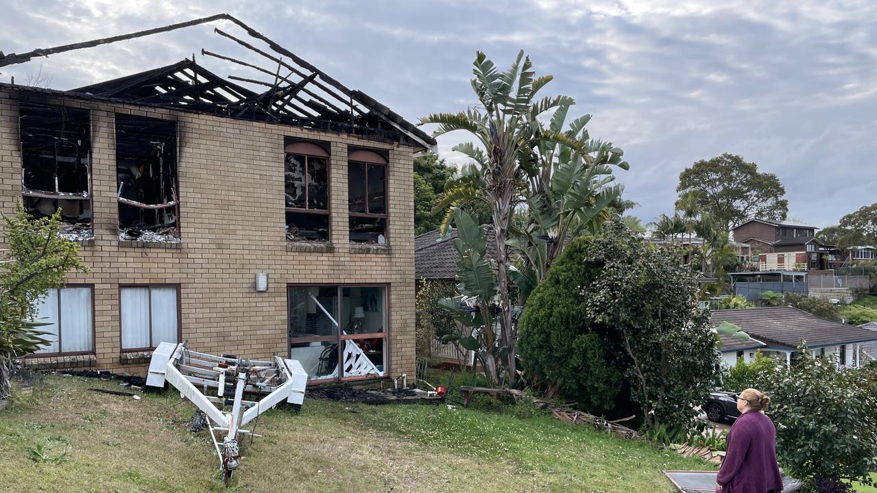 Michelle Down looks at her father’s house damaged in a fire. Picture: Ashleigh Tullis