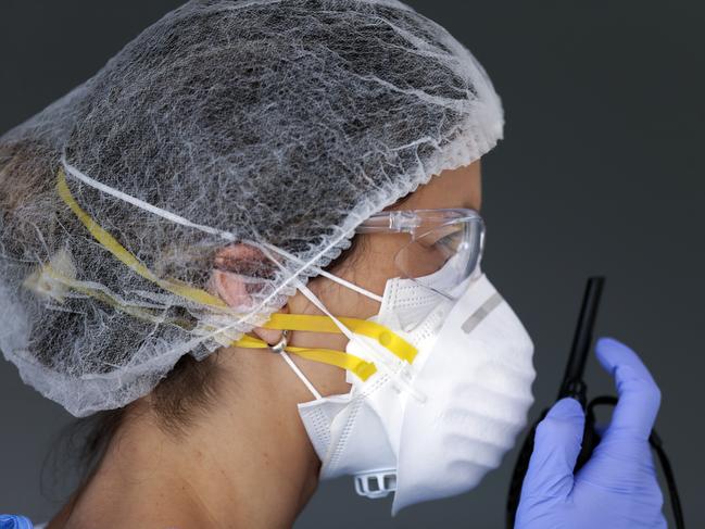 Serious uses too: a healthcare worker employee uses a walkie talkie <br/>at a drive-thru testing facility for COVID-19 in Uruguay on April 6.<br/>Photo: AP.