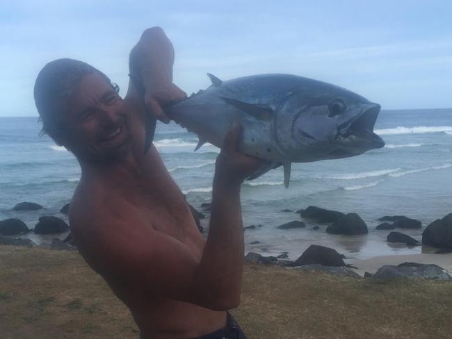 After snapping a photo with his prize, he threw the fish into the tray of his ute.