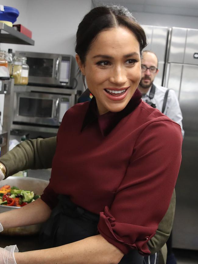 Meghan, Duchess of Sussex, donned maroon at a community kitchen in London. Picture: Getty Images