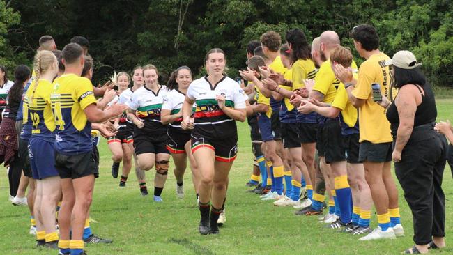 The Northlakes/The Bay women's rugby union being cheered onto the field by third grade. Picture: supplied