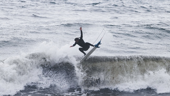 Matt Kennedy, of Clifton Beach, surfs wild weather at Pirates Bay on the Tasman Peninsula. Picture: MATT THOMPSON