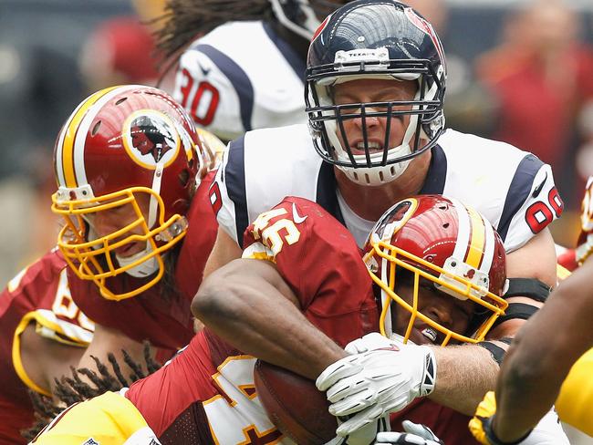 Alfred Morris #46 of the Washington Redskins is tackled by J.J. Watt #99 of the Houston Texans.